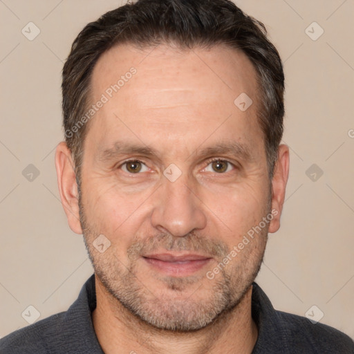 Joyful white adult male with short  brown hair and brown eyes