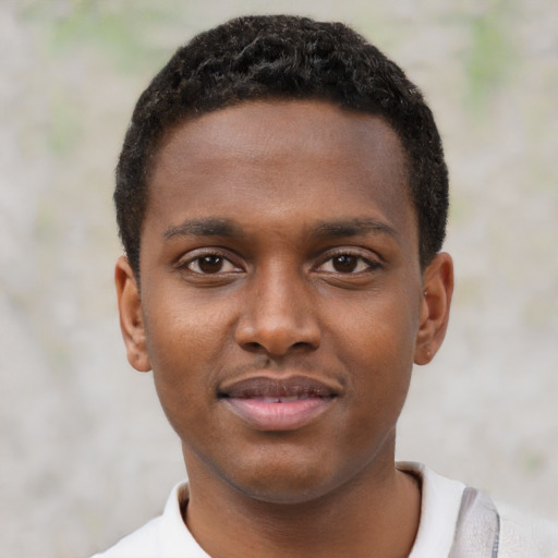 Joyful black young-adult male with short  black hair and brown eyes