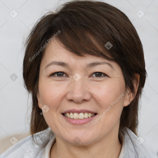 Joyful white adult female with medium  brown hair and brown eyes