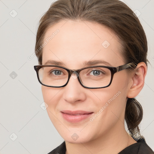 Joyful white young-adult female with medium  brown hair and grey eyes