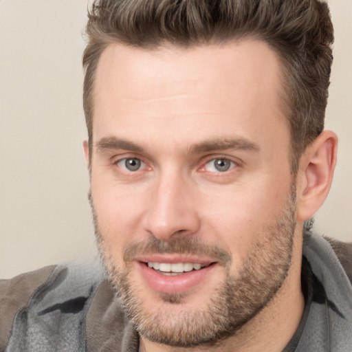 Joyful white adult male with short  brown hair and brown eyes