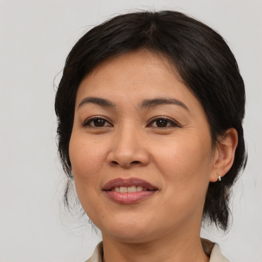 Joyful asian young-adult female with medium  brown hair and brown eyes