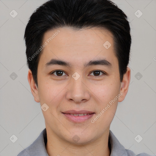 Joyful asian young-adult male with short  black hair and brown eyes