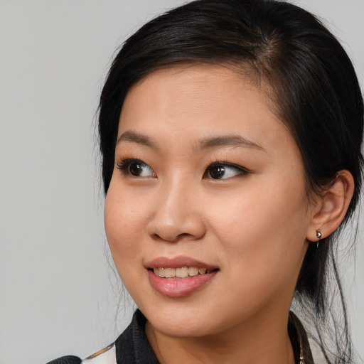 Joyful asian young-adult female with long  brown hair and brown eyes