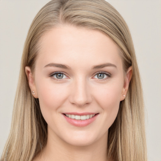 Joyful white young-adult female with long  brown hair and grey eyes