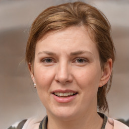 Joyful white adult female with medium  brown hair and grey eyes