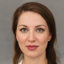 Joyful white young-adult female with medium  brown hair and blue eyes