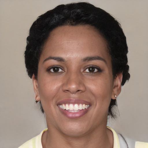 Joyful latino young-adult female with short  black hair and brown eyes