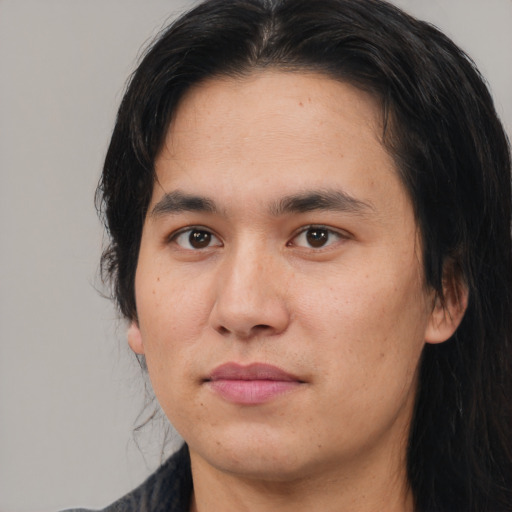 Joyful asian young-adult male with medium  brown hair and brown eyes