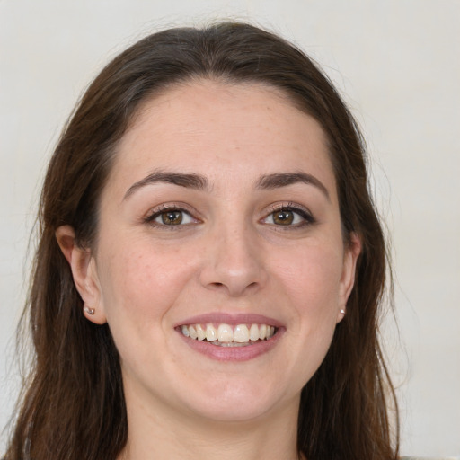 Joyful white young-adult female with long  brown hair and grey eyes