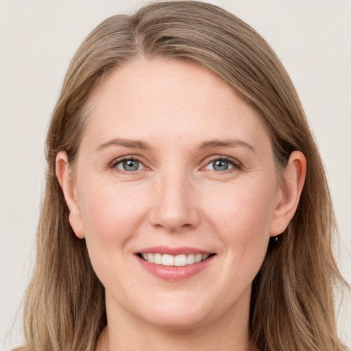 Joyful white young-adult female with long  brown hair and blue eyes