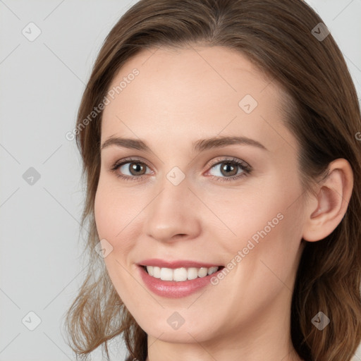 Joyful white young-adult female with long  brown hair and blue eyes