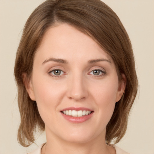 Joyful white young-adult female with medium  brown hair and green eyes