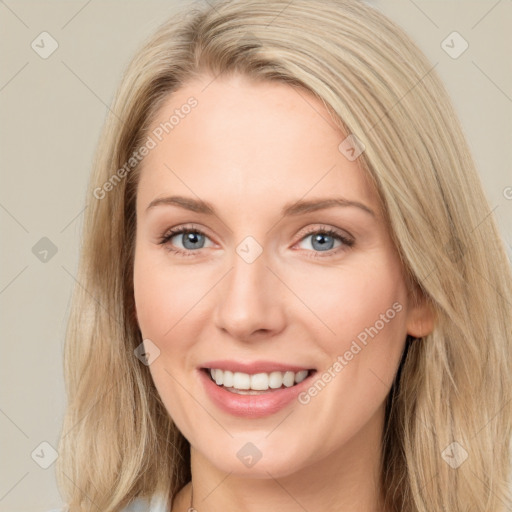 Joyful white young-adult female with long  brown hair and blue eyes