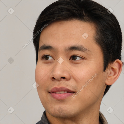 Joyful asian young-adult male with short  black hair and brown eyes