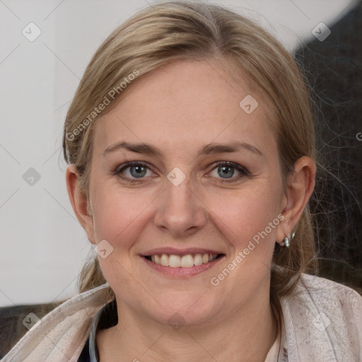 Joyful white adult female with medium  brown hair and blue eyes