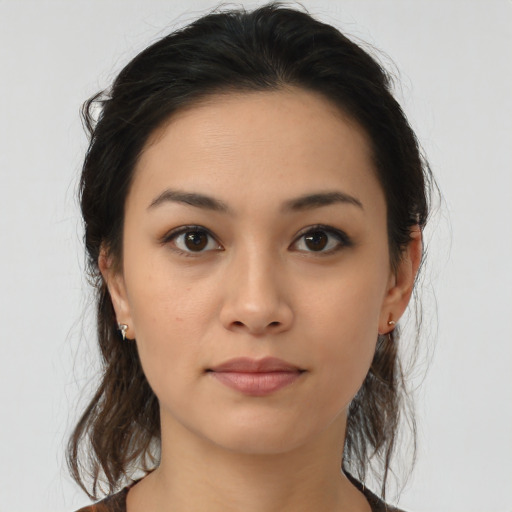 Joyful latino young-adult female with medium  brown hair and brown eyes