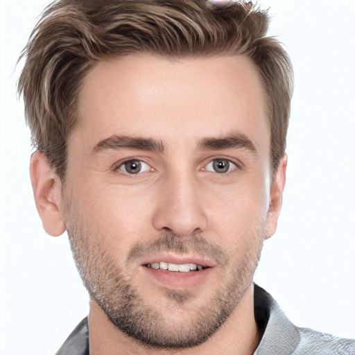 Joyful white young-adult male with short  brown hair and grey eyes