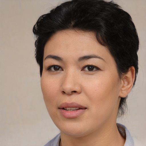Joyful asian young-adult female with medium  black hair and brown eyes