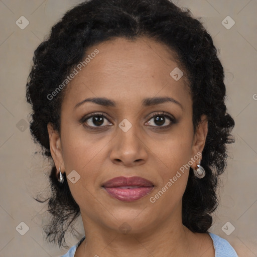 Joyful black adult female with medium  brown hair and brown eyes