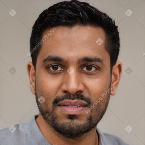 Joyful black young-adult male with short  black hair and brown eyes