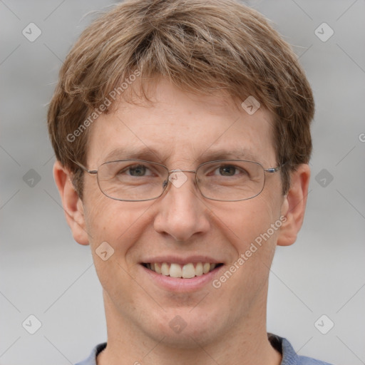 Joyful white adult male with short  brown hair and grey eyes