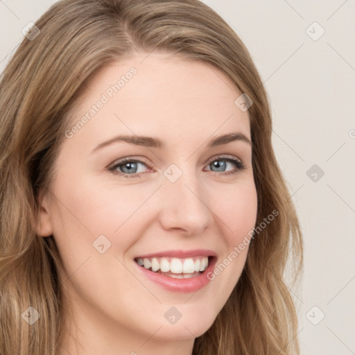 Joyful white young-adult female with long  brown hair and blue eyes