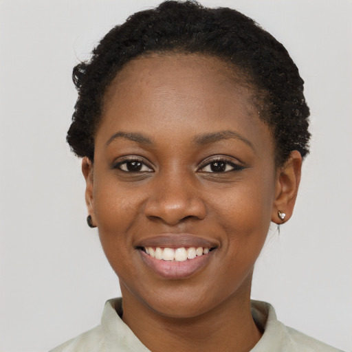 Joyful black young-adult female with short  brown hair and brown eyes