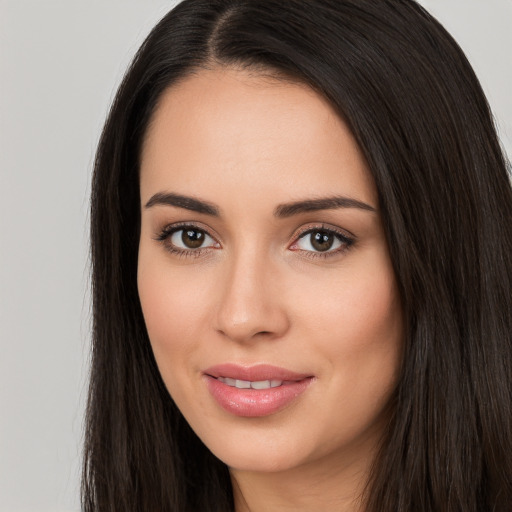 Joyful white young-adult female with long  black hair and brown eyes