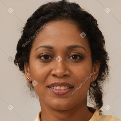 Joyful black adult female with medium  brown hair and brown eyes