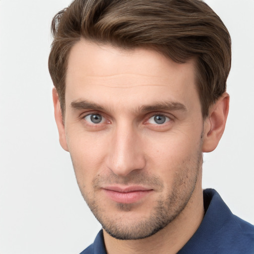 Joyful white young-adult male with short  brown hair and grey eyes