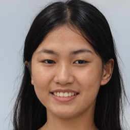 Joyful asian young-adult female with long  brown hair and brown eyes