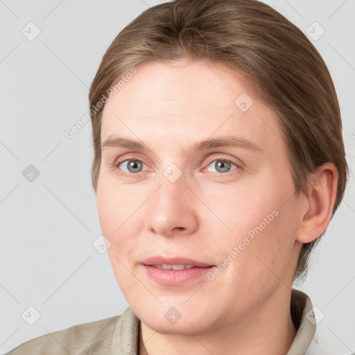 Joyful white young-adult female with short  brown hair and grey eyes