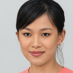 Joyful asian young-adult female with medium  brown hair and brown eyes