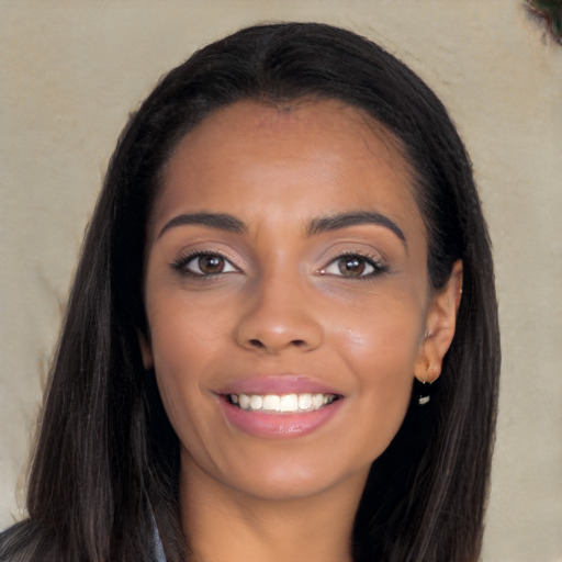 Joyful latino young-adult female with long  brown hair and brown eyes