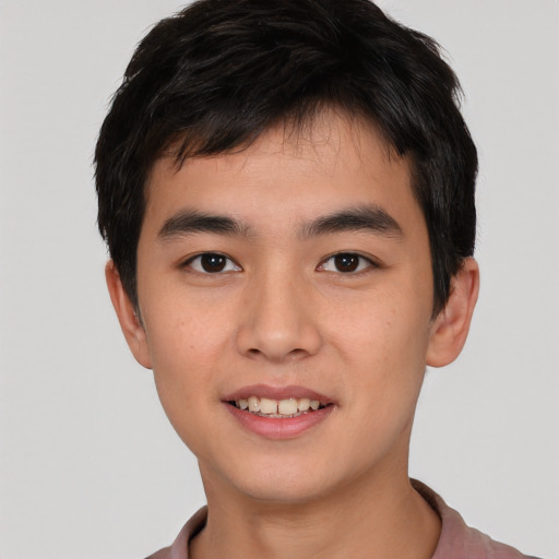 Joyful asian young-adult male with short  black hair and brown eyes