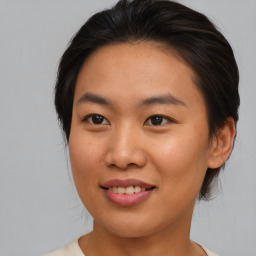 Joyful asian young-adult female with medium  brown hair and brown eyes