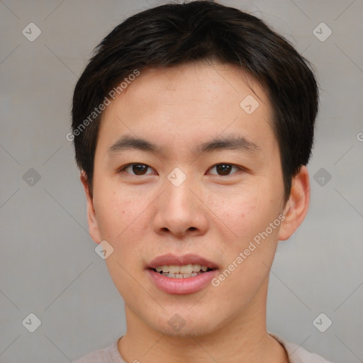 Joyful asian young-adult male with short  brown hair and brown eyes