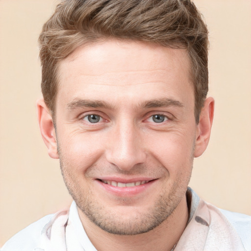 Joyful white young-adult male with short  brown hair and grey eyes