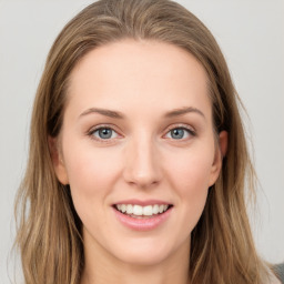 Joyful white young-adult female with long  brown hair and grey eyes