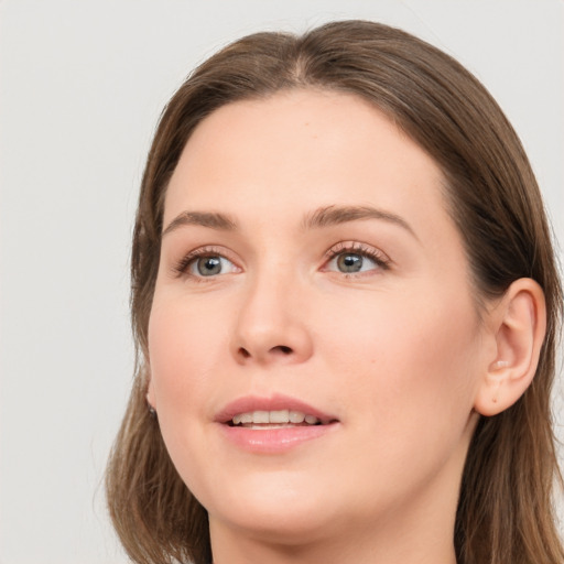 Joyful white young-adult female with long  brown hair and blue eyes