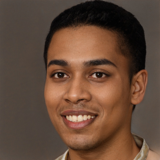 Joyful black young-adult male with short  black hair and brown eyes