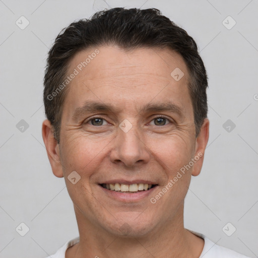 Joyful white adult male with short  brown hair and brown eyes