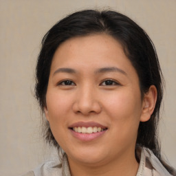 Joyful asian young-adult female with medium  brown hair and brown eyes