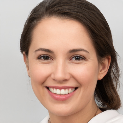 Joyful white young-adult female with medium  brown hair and brown eyes