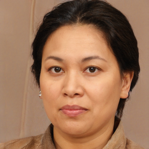 Joyful white adult female with medium  brown hair and brown eyes