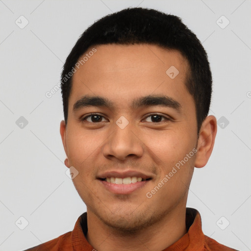 Joyful latino young-adult male with short  black hair and brown eyes