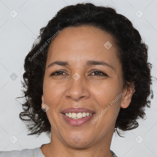 Joyful black adult female with short  brown hair and brown eyes