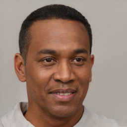 Joyful latino adult male with short  black hair and brown eyes