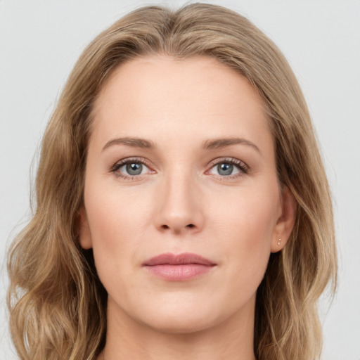 Joyful white young-adult female with long  brown hair and blue eyes